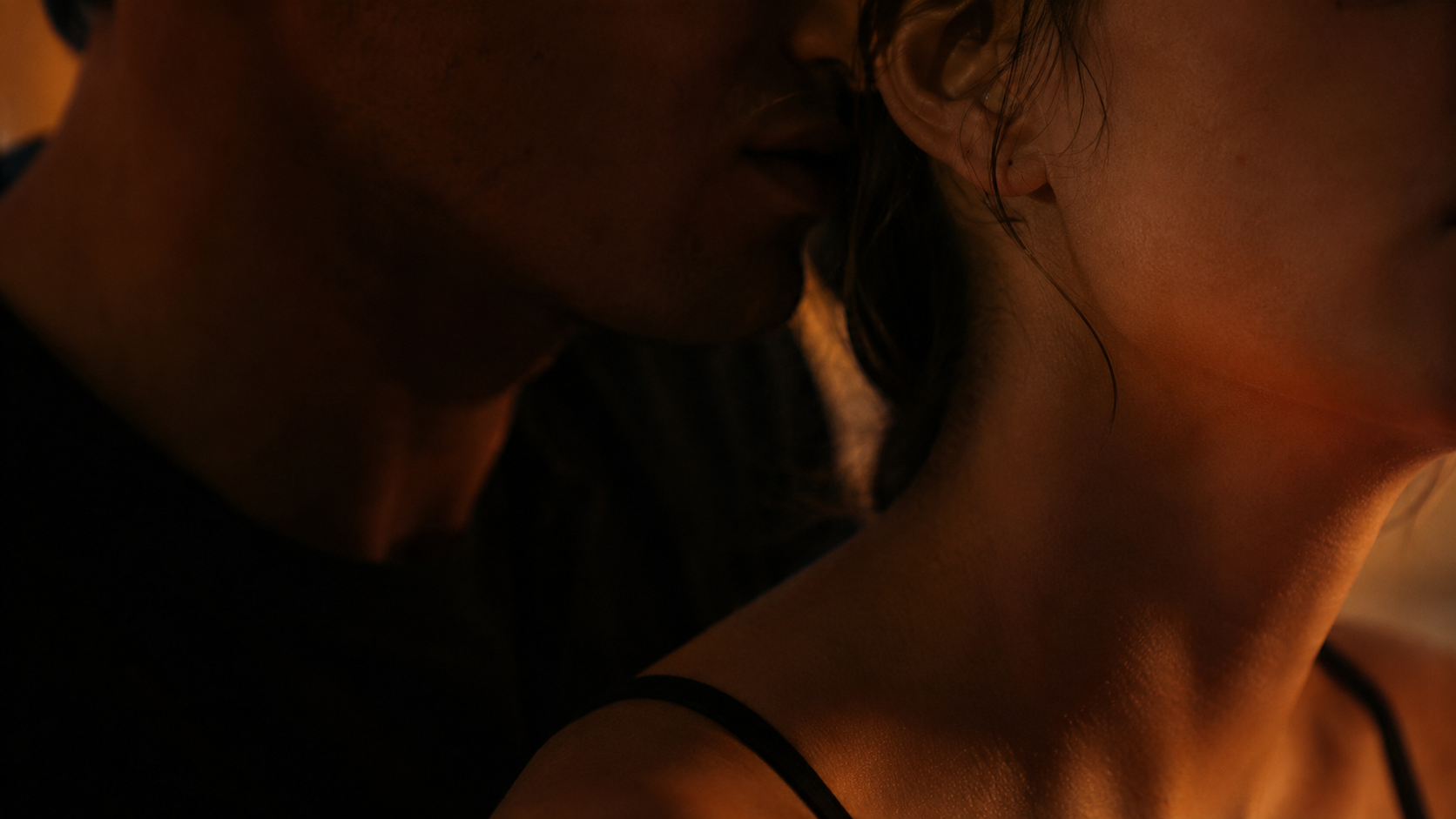 A close, whispered moment between two partners.