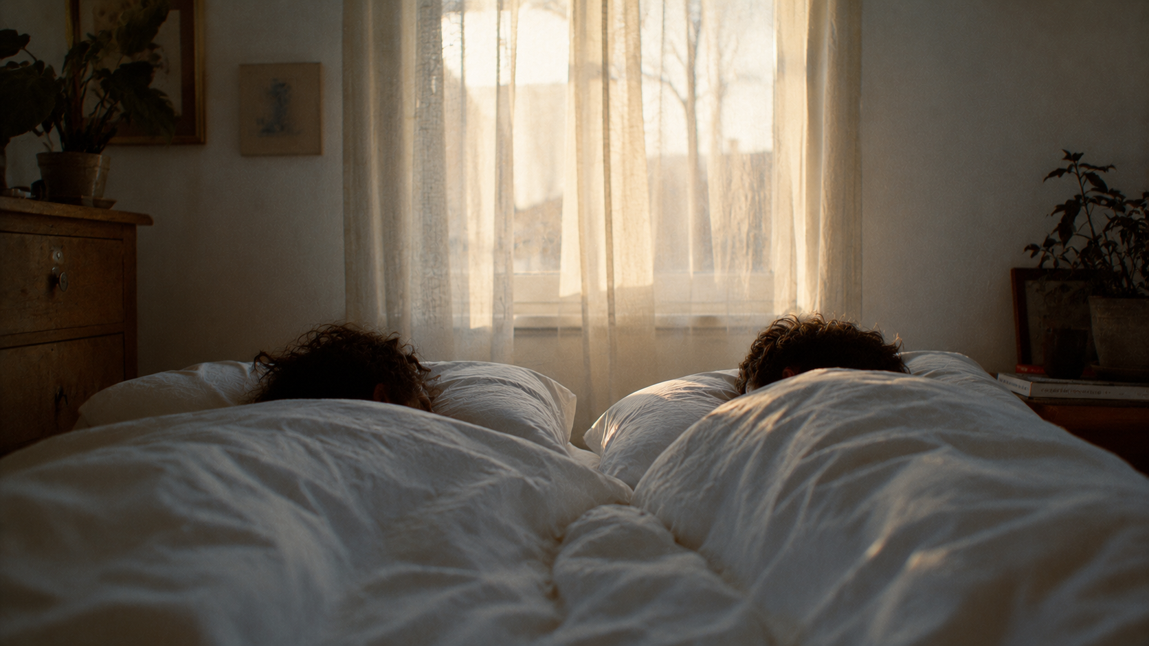 Two people lying side by side, not touching but close, soft window light.