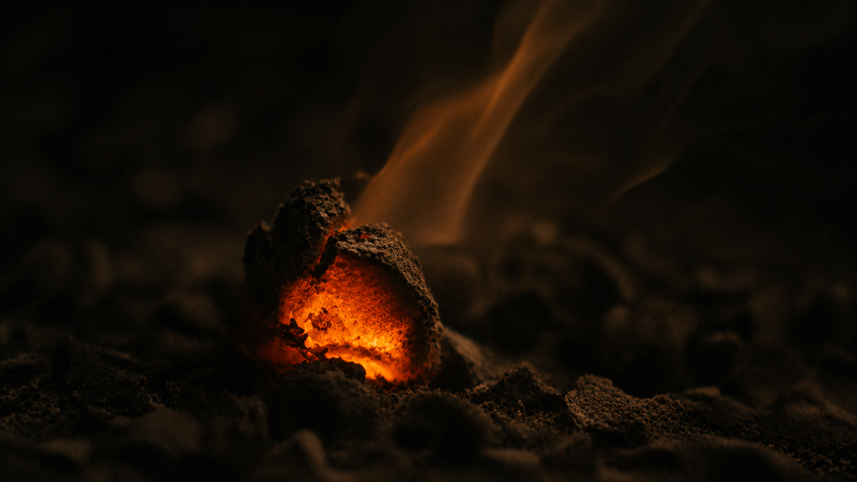 A single ember in low light, glowing.